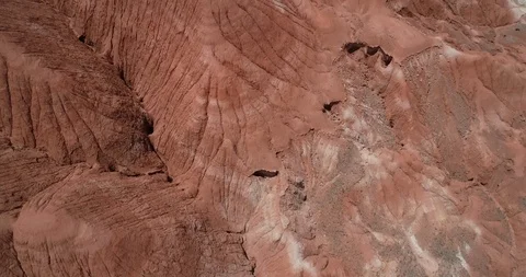Top to front view of aerial flying over red eroded dry mountainous landscape 스톡 동영상 103497986