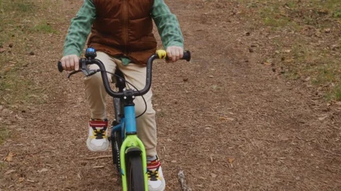 Top front view of boy cycling on dirt forest path Stock Footage 315756976