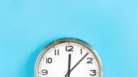 Top half of big wall clock on blue background Stock Photos
