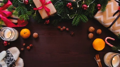 Top hands Santa Claus put a gift wrapped in red ribbon on the table. Stockbeeldmateriaal 70361978