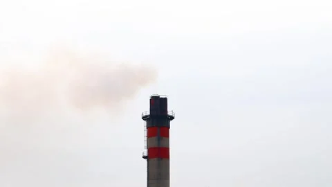 Top of the heating plant chimney timelapse showing dirty co2 smoke running into  Stock Footage 247435507