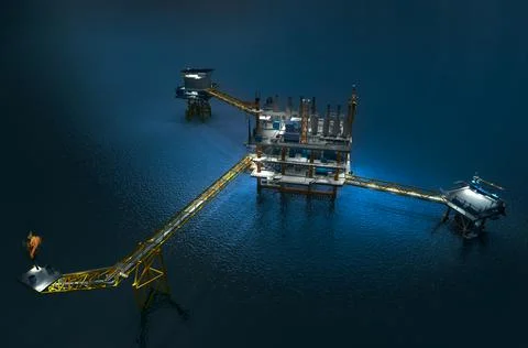 Top high angle view oil rig building on the sea in night time Ilustración de archivo