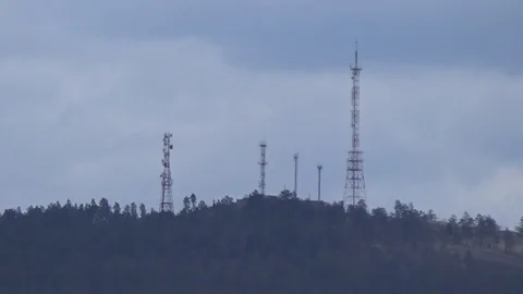 On the top of the hill is a cellular tower Stock Footage 75334835