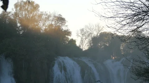 Top of Kravice waterfall at sunset seen through mist Stock Footage 60382996