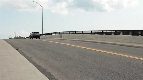 Top of large big bridge road with cars vehicles traffic coming and going passing Video stock 247753551
