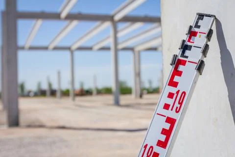 Top of leveling rod for measuring level on construction site Stock Photos