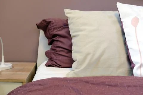Top lights, bedside chest. A bedside rug. Bed soft blanket pillows. The Stock Photos