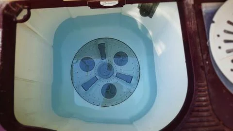 Top load washing machine inside view filled with water Stock Photos