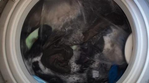 Top loading washing machine washes laundry such as colored clothing and sheet Stock Footage 85984963