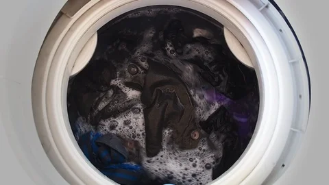 Top loading washing machine washes laundry such as colored clothing and sheet Stock Footage 86606958