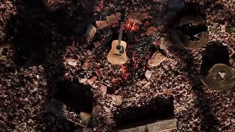 Top Lockdown View Of Sunlight On Guitar By Burning Leaves In Forest - Crested Stock Footage 254723787