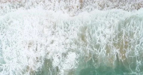 Top look down view of sea beach waves of turquoise water on beach Stock Footage 134861635