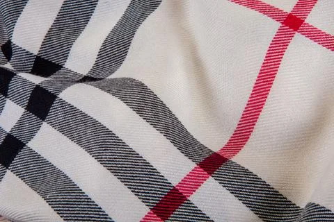 Top macro view on draped milky checked scarf with seamless textile pattern Stock Photos