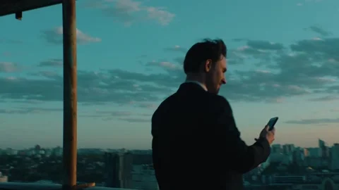 Top manager uses a smartphone with a view of the city Stock-Footage 131400357