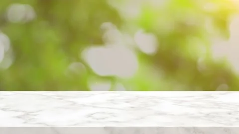 Top marble stone texture on green tree bokeh background Stock Footage 132597126