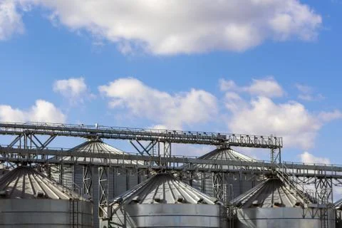 The top of the metal structures of the grain elevator on the background of th Stock Photos