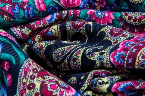 Top micro view on folded dark soft cotton scarf with bright floral print Stock Photos
