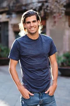 Top model man using blue t-shirt and looking at camera for social media or Stock Photos