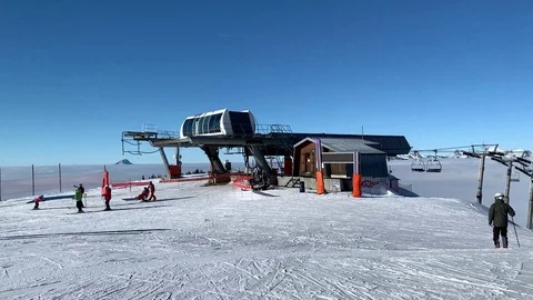 Top of mountain, above clouds, pan, skiing, 60fps Stock Footage 104169227