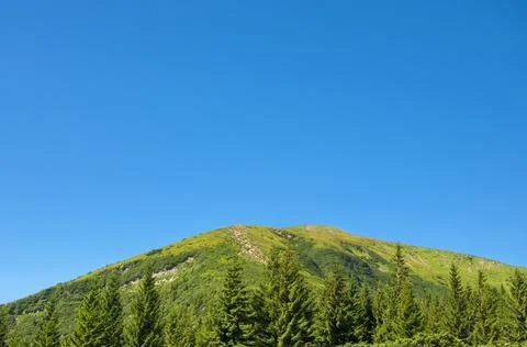 The top of the mountain against the blue cloudless sky Stock Photos