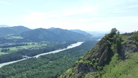The top of the mountain and a river in the distance, filmed with a drone Stock Footage 259696743