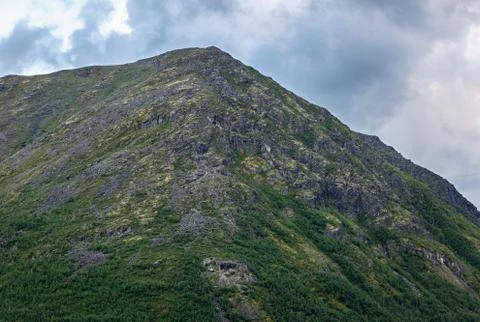 Top mountain Khibiny in the form of a background of the cloudy sky. Stock Photos