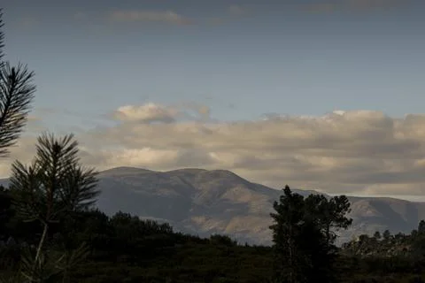 Top a mountain range showing in the background Stock Photos