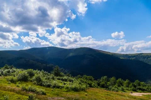 The top of the mountain in the shadow of a large cloud with thickets of bushe Foto stock