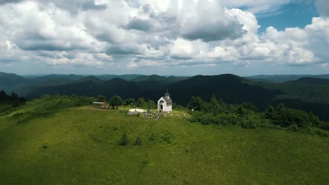 The top of the mountain with a small church. A small beautiful church on top of Stock Footage 283223071