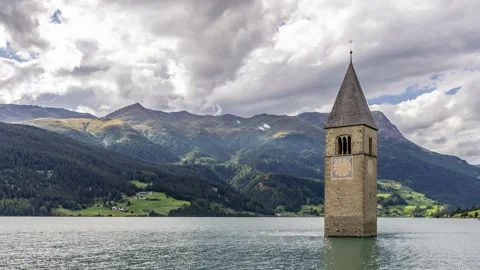 The top of the old bell tower of Curon (Graun) emerges from the waters Stock Footage 138875272