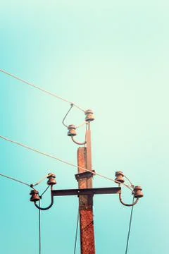 Top old electrical pillar on a background of the blue sky Stock Photos