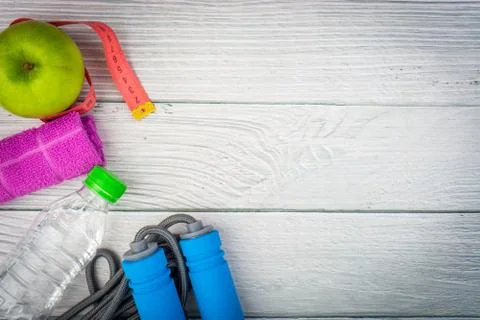 Top or flat lay view of healthy and gym, excercise kits on wooden background 库存照片