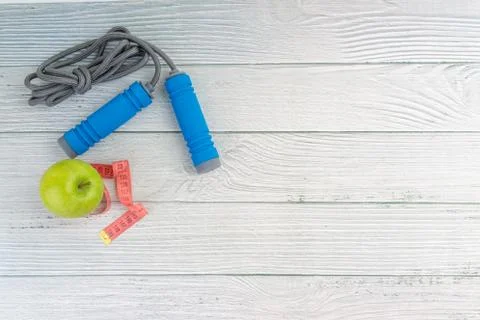 Top or flat lay view of apple fruit and skipping rope with copy space area on Stock Photos