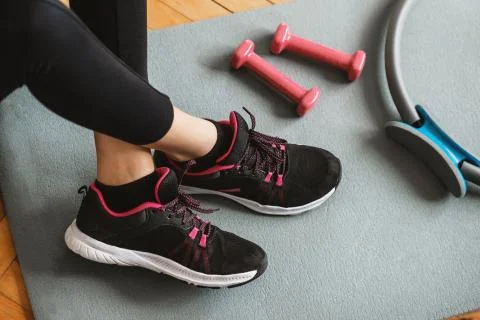 Top or flat view  of black running shoe with dumbbells. Healthy concept. Stock Photos