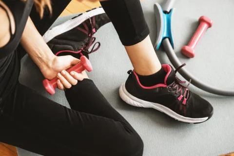 Top or flat view of a young girl with running shoe and dumbbells Stock Photos