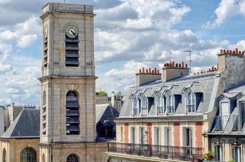 Top part of clock tower of catholic church in Paris 库存照片