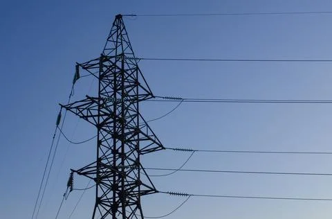 Top part of high voltage post. High-voltage tower sky background. Space for text Stock Photos