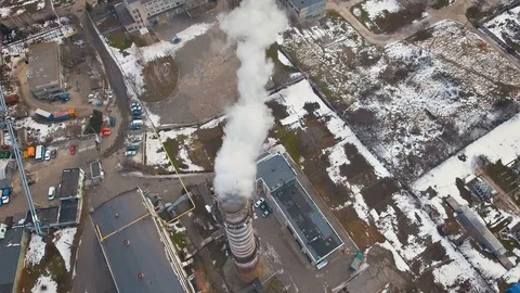 Top of the pipe with steam during the winter heating season (aerial shot). 4K Video stock 72133195