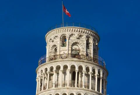 The top of the Pisa Tower with flag Stock Photos