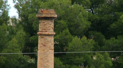Top of red brick chimney with trees in background Stock Footage 47977825