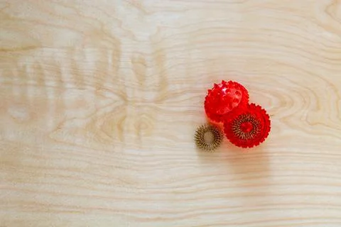 Top right position opened red spiked ball with metal rings background Stockfoto's