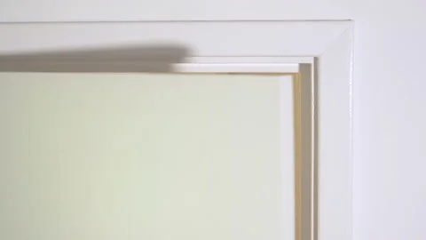 Top right of a white interior door being opened then closed. Stock-Footage 159141189