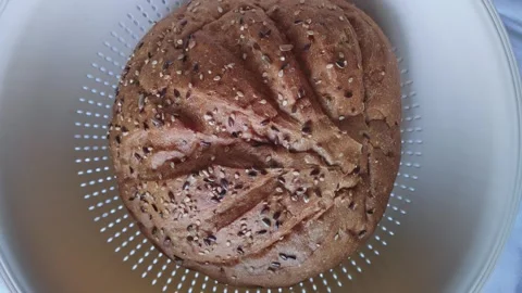 Top rotating view of soft fluffy multigrain bread in a basket on a table Stock Footage 254702047