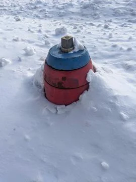 Top Section of Red and Blue Fire Hydrant Sticking Out of Deep Winter Snow Ban Stock Photos