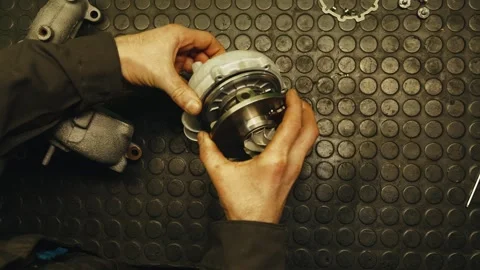 Top shot of auto mechanic assembling a car turbine after repair and maintenance Stock Footage 284545464