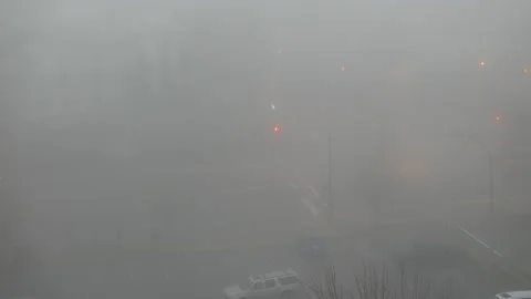 Top shot of car driving through an intersection with heavy fog Stock Footage 116753739