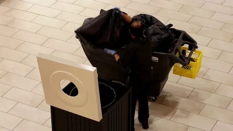 Top shot of cleaner changing garbage bag inside Coquitlam shopping mall Video stock 73429097