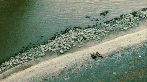 Top Shot of a couple lying in front of the sea Stock Footage 67298967