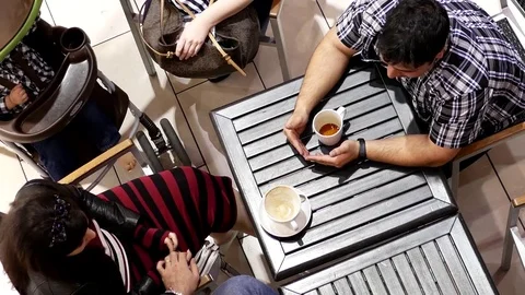 Top shot of customer drinking coffee and chatting with friend Stock Footage 74575179