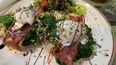 Top shot of eggs benedict and at a cozy, digital nomad brunch cafe in Lisbon Stock Footage 238841265